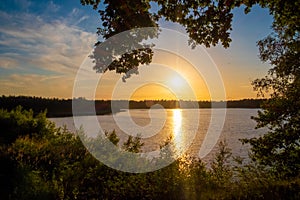 Panorama of a gorgeous sunset at a forest lake