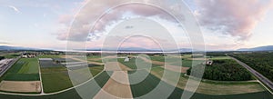 Panorama of green fields and lake