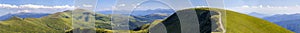 Panorama of green hills in summer mountains with gravel road for photo