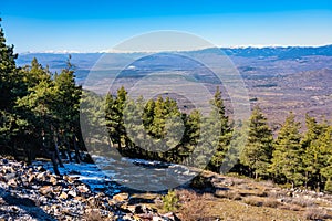 Panorama of green landscape of mountain range with snowy peaks, Guadarrama, Madrid, Spain.