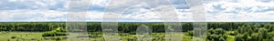 Panorama of green trees and blue sky