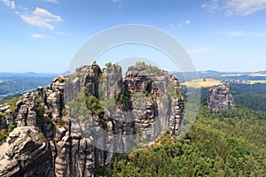 Panorama with Group of rocks Schrammsteine and Falkenstein seen from viewing point in Saxon Switzerland