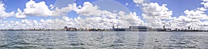 Panorama of heavy harbor jib cranes and ships on the pier in the Klaipeda Sea Port