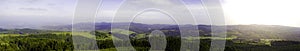 Panorama with hills, forests, plants and sky