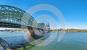 Panorama of the Hohenzollern bridge over Rhine river on a sunny day. Beautiful cityscape of Cologne, Germany with cathedral