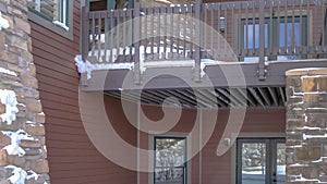 Panorama Home with balcony over snowy entrance built on Wasatch Mountain neighborhood