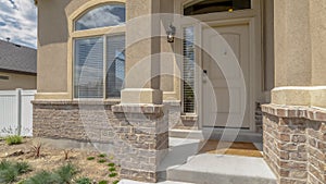 Panorama Home entrance with steps white front door sidelight arched windows and yard