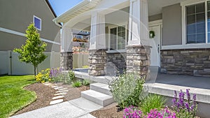 Panorama Home facade with plants flowers and pathway on the yard in front of the poch