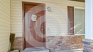 Panorama Home facade with white siding and stone bricks wall and concreate front porch