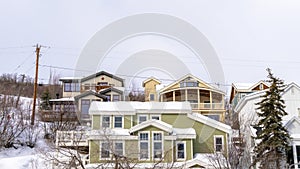 Panorama Homes on snowy residential mountain slope in scenic Park City Utah in winter