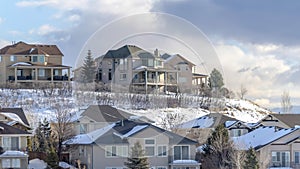 Panorama Homes on sunlit Wasatch Mountain slope blanketed with pristine snow in winter