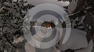 Panorama house chalet during a snowfall in the trees winter forest at night in the moonlight