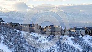 Panorama Houses on snowy mountain overlooking Wasatch Mountains and residential valley