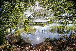 Panorama on huge lake or river with reflexion in morning with beautiful awesome pink sunrise