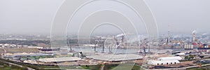 Panorama of hydrocarbon refinery and liquefied natural gas tanks at overcast day