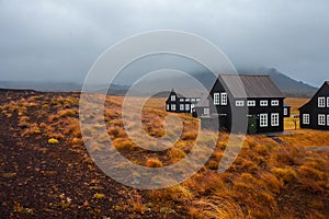 Panorama of Iceland, the harsh weather, mountains and black house