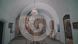 Panorama of the inner part of the Orthodox chapel. Visible iconostasis and icons on the walls.