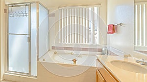 Panorama Interior of a bathroom with built in bathtub vanity area and separate shower