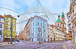Panorama of Karmelitska Street with old houses and St Nicholas Church, Prague, Czech Republic