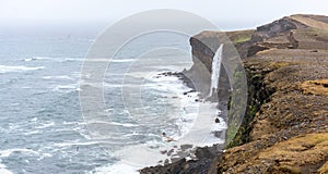 Panorama of KetubjÃ¶rg bird cliffs and waterfall in the Skagi peninsula in Iceland.