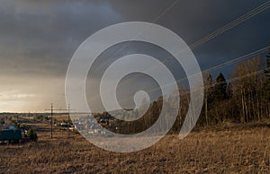 Panorama of Klin-Dmitrovsky ridge with villages and high voltage line in early spring, Sergiev Posad district, Moscow region, Russ