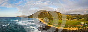 Panorama of Koko Head crater taken from a drone in Hawaii with both a rocky and a sandy beach with the incoming surf