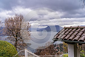 panorama of lake Maggiore on a rainy day with heavy low clouds covering part of the coast