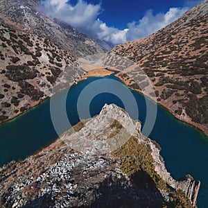 panorama of the landscape of Lake Koksay with blue clear water in Tien Shan mountains in Kazakhstan in autumn. Top view