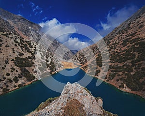 panorama of the landscape of Lake Koksay with blue clear water in Tien Shan mountains in Kazakhstan in autumn. Top view