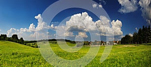 Panorama landscape with meadow and cloudy sky