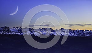 Panorama landscape view of Alps in Switzerland from the top of Rigi Kulm on twilight time and C-shaped of the moon