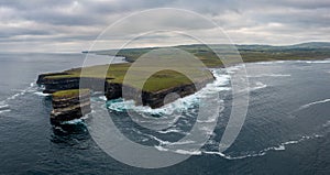 Panorama landscape view of the wild and rugged coastline of County Mayo in Ireland with the Downpatrick Head sea stack in the