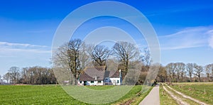 Panorama of a little white farm in nature area Drents-Friese Wold