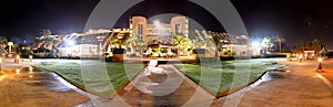 The panorama of luxury hotel in night illumination