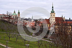 Panorama of Mala Strana in Prague behind the trees of the Petrin garden