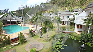 panorama of man playing guitar and walking around pools