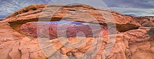 Panorama of Mesa Arch on a cloudy day, Canyon Lands National Park, USA