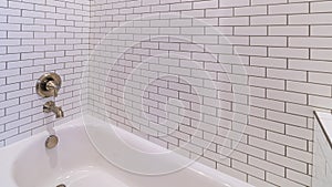 Panorama Modern tiled white bathtub with shower bright interior