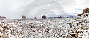 Panorama of Monument Valley covered in freshly fallen snow on a cloudy day