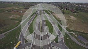 Panorama of the motorway with a bird`s eye view. Transport artery of the country. The movement of vehicles on the highway. Landsca