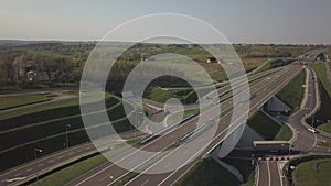 Panorama of the motorway with a bird`s eye view. Transport artery of the country. The movement of vehicles on the highway. Landsca