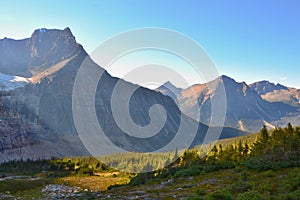 Panorama of Mount Edith Cavell. High mountains with glacier, sun rays illuminate the forest.