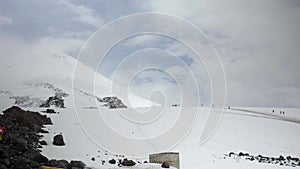 Panorama of mount Elbrus. Climbers are climbing.