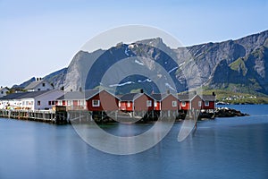 Panorama of mount Olstind above the red fishing houses called Rorbu in town of Hamnoy on Lofoten islands, Norway