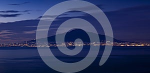 Panorama of Mount Vesuvius at night with city lights of Naples, Italy