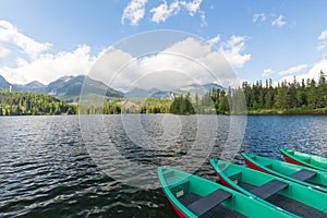 Panorama mountain lake Strbske Pleso in the Tatra mountains. Summers colors and boat for swimming