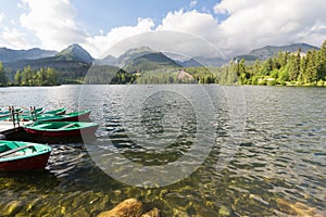 Panorama mountain lake Strbske Pleso in the Tatra mountains. Summers colors and boat for swimming