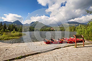 Panorama mountain lake Strbske Pleso in the Tatra mountains. Summers colors and boat for swimming