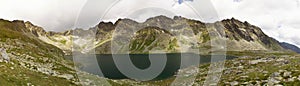 Landscape of panorama of the picturesque lake surrounded by mountain peaks