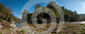 Panorama of a mountain river with a beautiful view shot against a blue sky